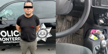 Man with a Black Bar over His Eyes Stands with Hands Behind His Back Beside a Black Police Vehicle Marked Monterrey Sspc. for Context: Informative Image of a Person Near a Police Car. - Nuevo León Primero