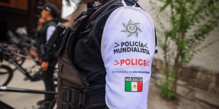Police Officer's White Sleeve Patch Reads 'policÍa Mundialista' and 'police' with the Mexican Flag Nearby, in Tactical Gear. - Nuevo León Primero