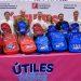 Marcelo-segovia-asiste-utiles-utiles-mty - Nuevo León Primero Group of Eight Adults Standing Behind a Table with Red and Blue Mty Backpacks at a Back-to-school Event. the Banner Shows Education Ministry Logos in Spanish Context. - Nuevo León Primero
