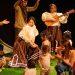 Teatro Para Bebés - Nuevo León Primero Group of Performers on a Stage with Children Dancing; a Woman Plays a Guitar As Others Guide the Kids. - Nuevo León Primero