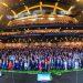 - Nuevo León Primero Huge Group of People in Formal Attire Posing on a Multi-tiered Stage in a Modern Auditorium; 'juntos' Signs Visible at Front. - Nuevo León Primero